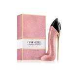 Pink glittery high heel shoe with 'Good Girl' Carolina Herrera packaging on a white background