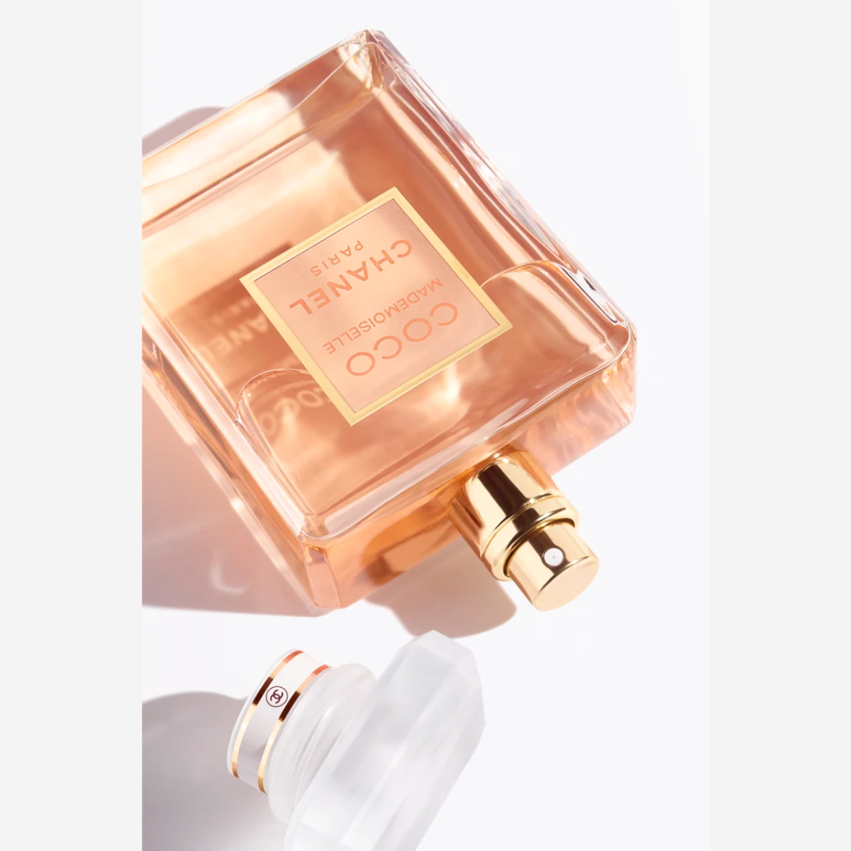 Chanel perfume bottle with gold cap on a white background