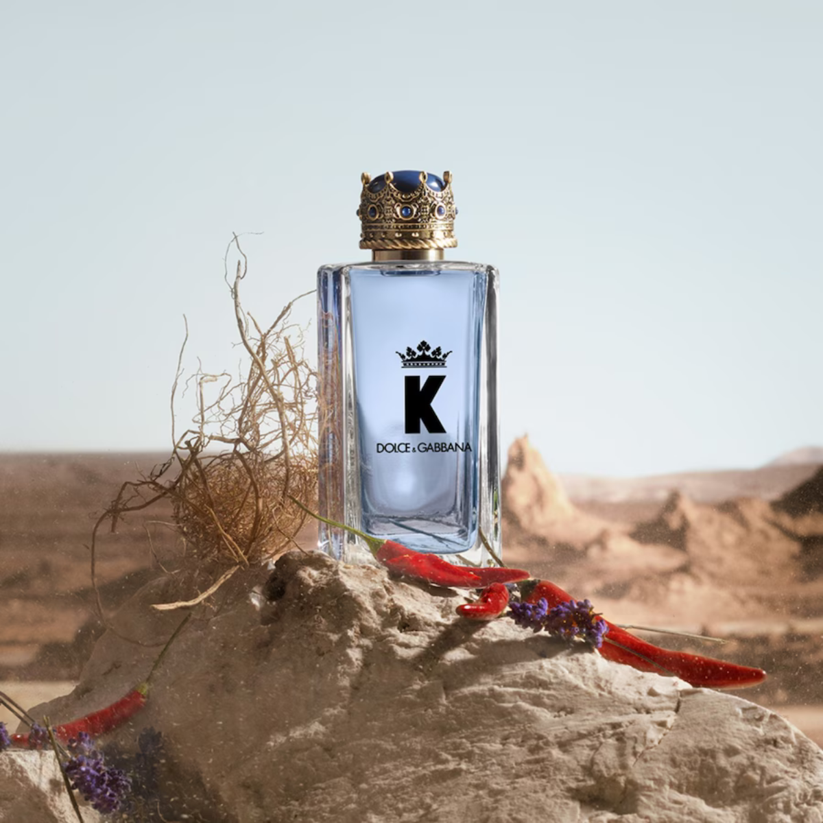 Dolce & Gabbana K perfume bottle on a desert background