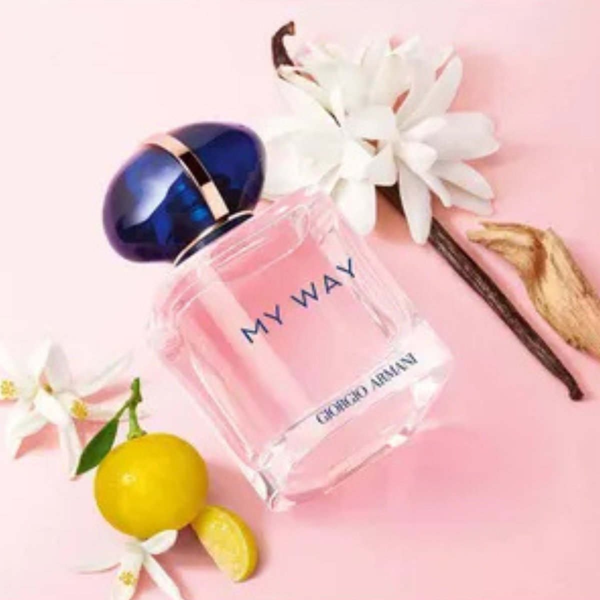 Giorgio Armani 'My Way' perfume bottle with flowers and a lemon on a pink background