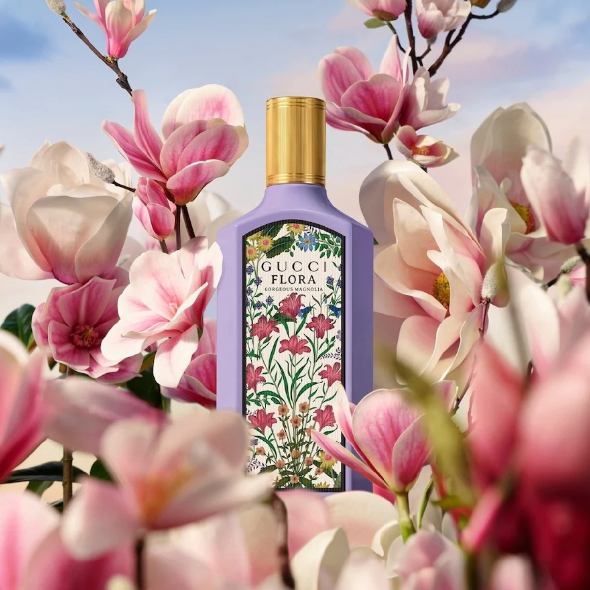 Gucci Flora perfume bottle surrounded by pink flowers with a blue sky background