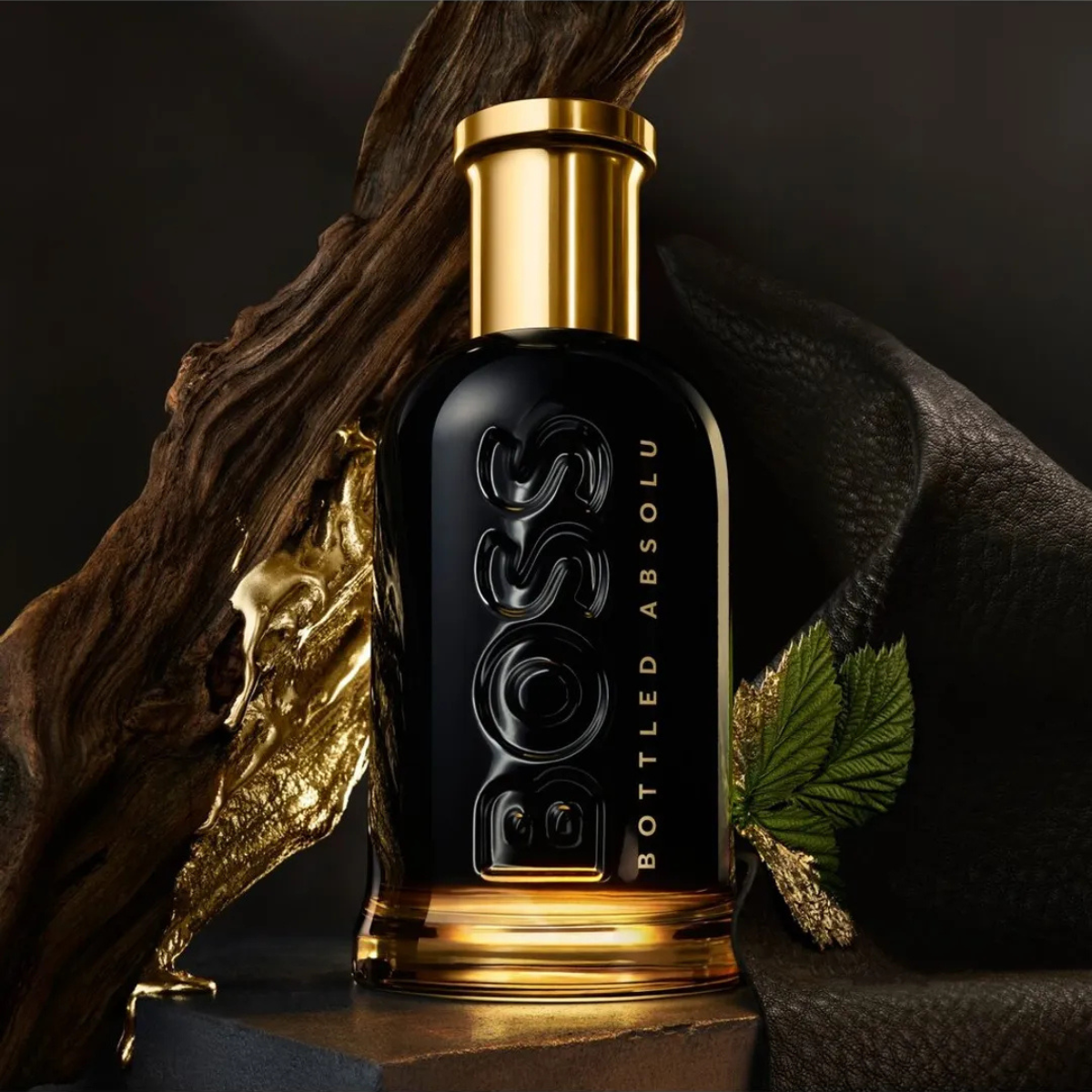 BOSS Bottled Absolu perfume bottle with gold cap and black body on a dark background