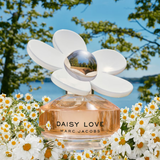 Marc Jacobs Daisy Love perfume bottle with a floral background