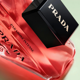 Prada Paradoxe Intense perfume bottle on a red satin background
