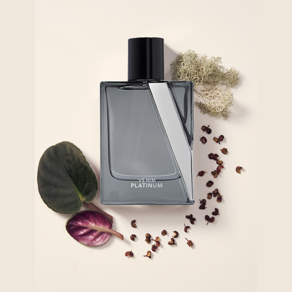 Perfume bottle labeled 'YSHIN Platinum' with dried flowers and leaves on a light background